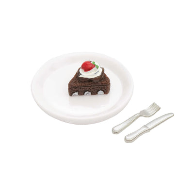 Tarta de chocolate en miniatura con plato y cubiertos